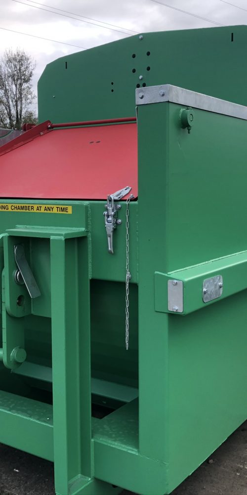 Gradeall GPC P24 compactor featuring a manual loading hopper with a drop-down door for easy waste disposal.