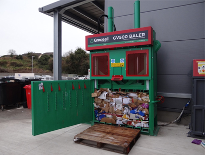 Full chamber of waste cardboard in Gradeall GV-500 baler ready for ejection