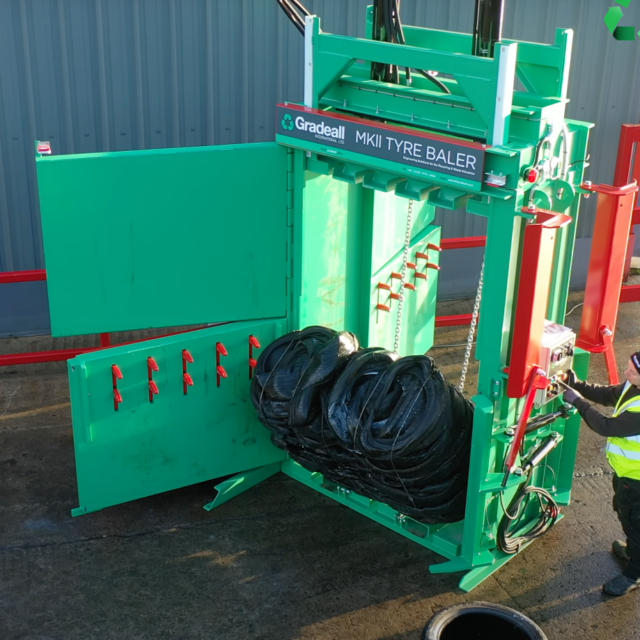 Ejection of a tyre bale from a Gradeall MK2 tyre baler, capturing a crucial moment in the recycling process.