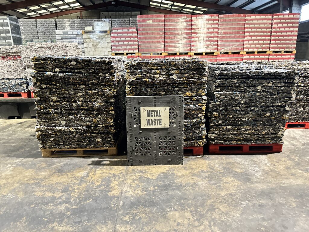 Stacked aluminium bales ready for recycling, produced by a high-capacity can baler.
