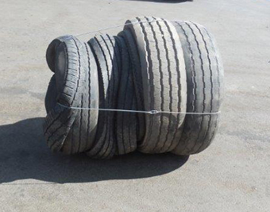 Single bale of truck tyres secured with baling wire from the Gradeall Truck Tyre Baler.
