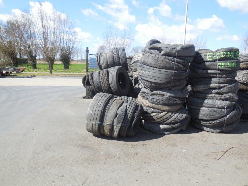 Stacks of truck tyre bales in a storage yard, compacted by a Gradeall Truck Tyre Baler.