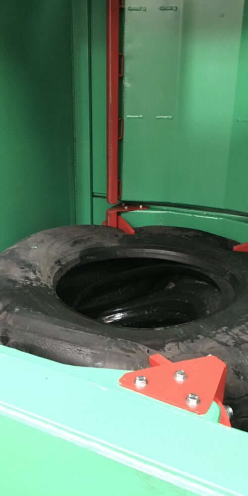 Inside view of the Gradeall Truck Tyre Baler with door-mounted tyre retainers.