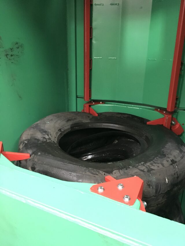 Inside view of the Gradeall Truck Tyre Baler with door-mounted tyre retainers.
