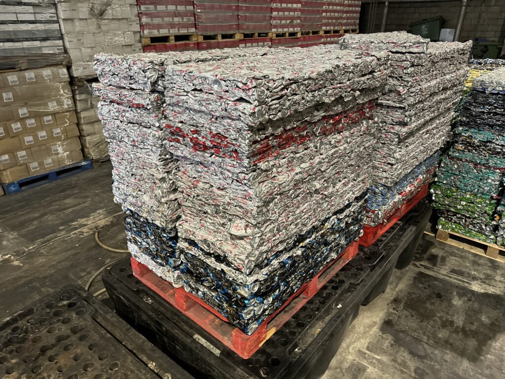 Stacked bales of scrap aluminium cans, compressed by a drink can crusher machine.