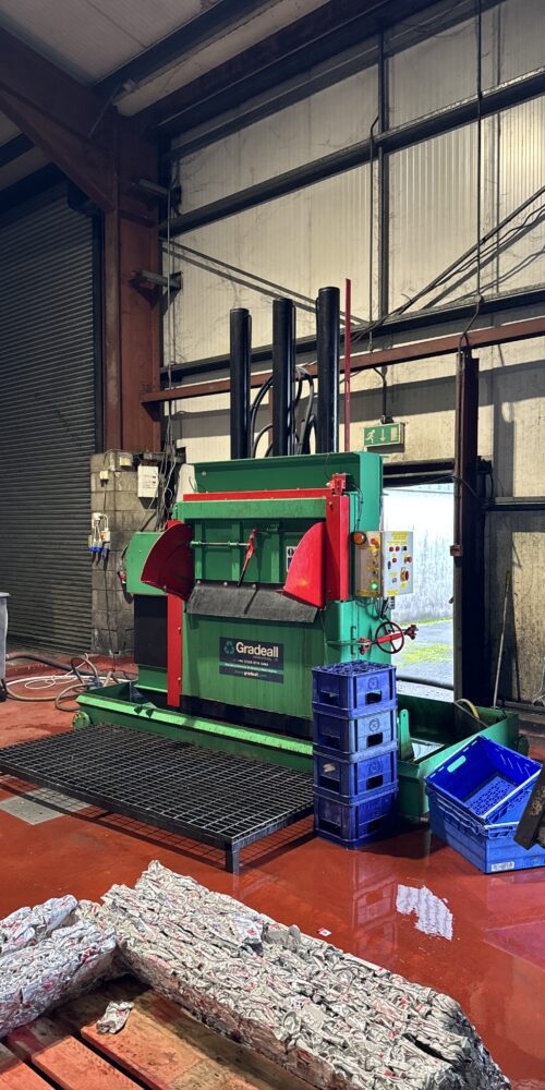 Gradeall GVC 750 Can Baler compressing aluminium cans into bales in an industrial setting.