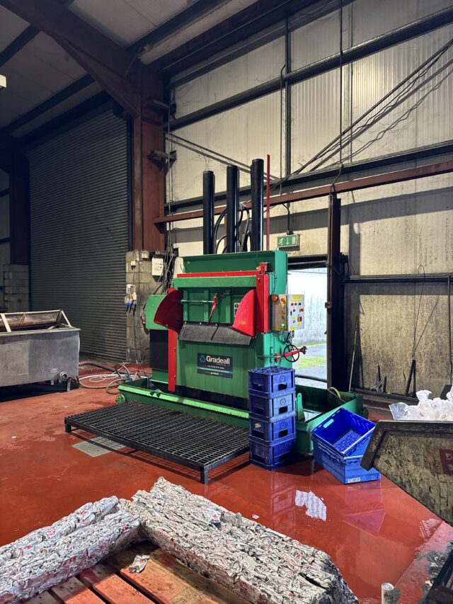 Gradeall GVC 750 Can Baler compressing aluminium cans into bales in an industrial setting.
