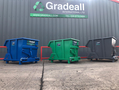 Gradeall tipping skips in front of factory