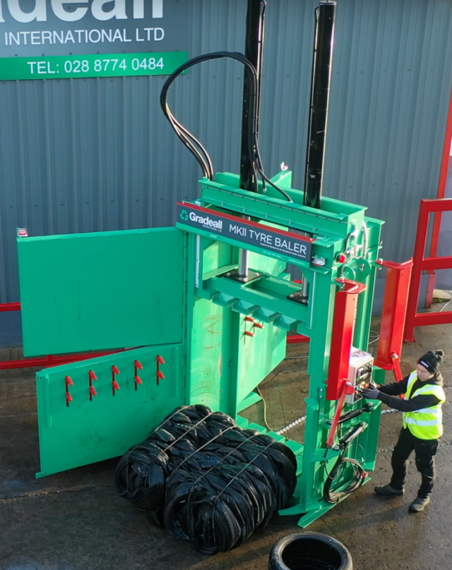 A tire bale being ejected from a tire baler