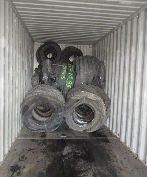 Inside a 40 ft shipping container with truck tyre bales from Gradeall Truck Tyre Baler.