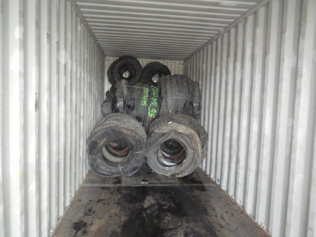 Inside a 40 ft shipping container with truck tyre bales from Gradeall Truck Tyre Baler.