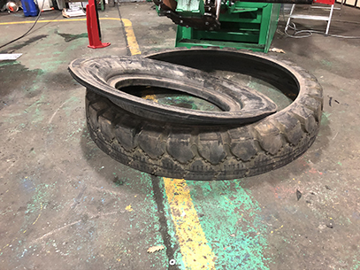 Cut OTR tyre showing separated tread and inner sidewall after processing