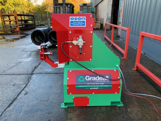 Gradeall Car Tire Sidewall Cutting machine with an example of cut tire and sidewalls