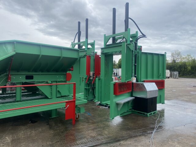 Photo of two MK2 tyre balers in front of an inclined tyre baler conveyor in an outdoor industrial setting.