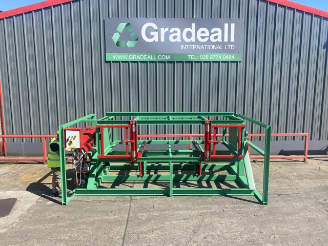 Gradeall Pallet Inverter ready for operation at a facility, with a technician at the control panel