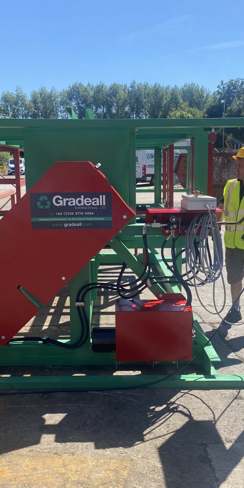 Worker operating a Gradeall Pallet Inverter outdoors